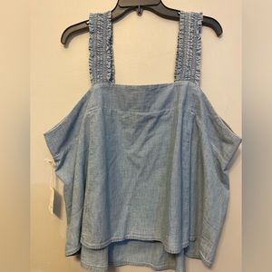 Denim blue sleeveless top with elastic in the front and back and the shoulder